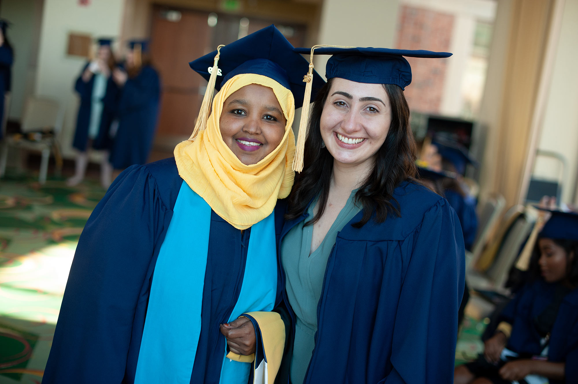 Two women in graduation caps and gowns