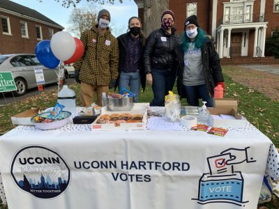 volunteers at a polling place on Election Day 2020 with donuts and coffee for voters